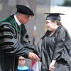 Michelle Bailey shakes Chancellor Robin Gary Cummings' hand after receiving her hard-earned sociology degree at UNC Pembroke Spring Commencement on Saturday May 4, 2024